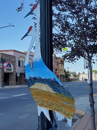 Painted metal crane on lamppost in Monte Vista, Colorado
